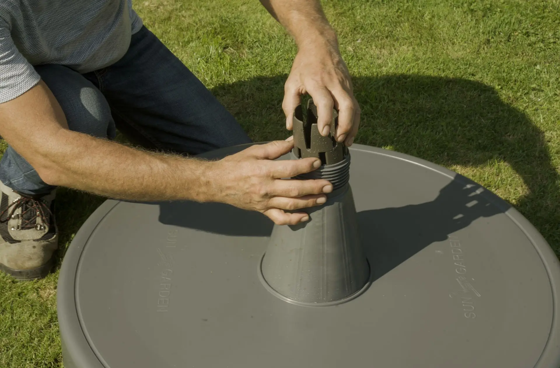 Tightening top of parasol base onto bottom of parasol base